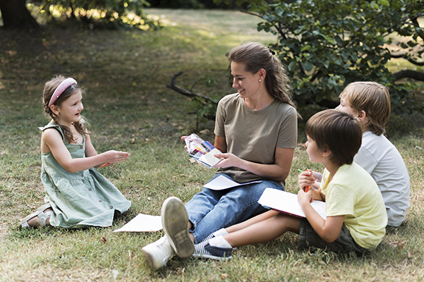 Children participating in outdoor lesson with teacher supervision