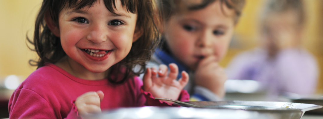 Smiling preschool child in a classroom at Bright Beginnings Early Learning Center